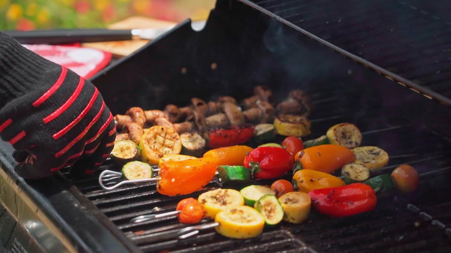 Vegetable skewers cooking on a grill